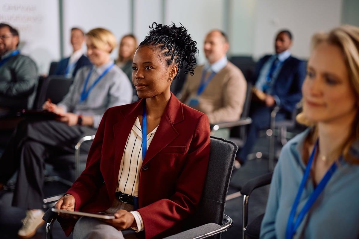 African American businesswoman leading a seminar with coworkers in a modern boardroom